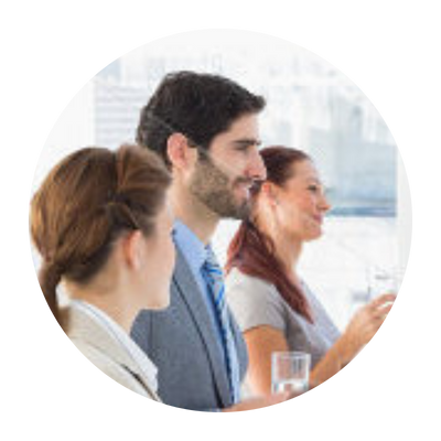 Three people standing in an office, smiling.