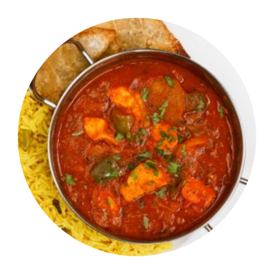 Bowl of curry with rice and bread.